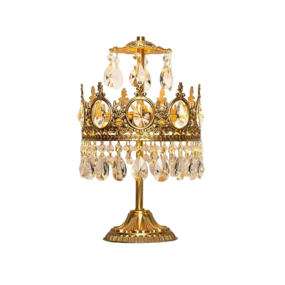 Vintage crystal table lamp with gold base and hanging crystal accents on white background