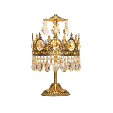 Vintage crystal table lamp with gold base and hanging crystal accents on white background